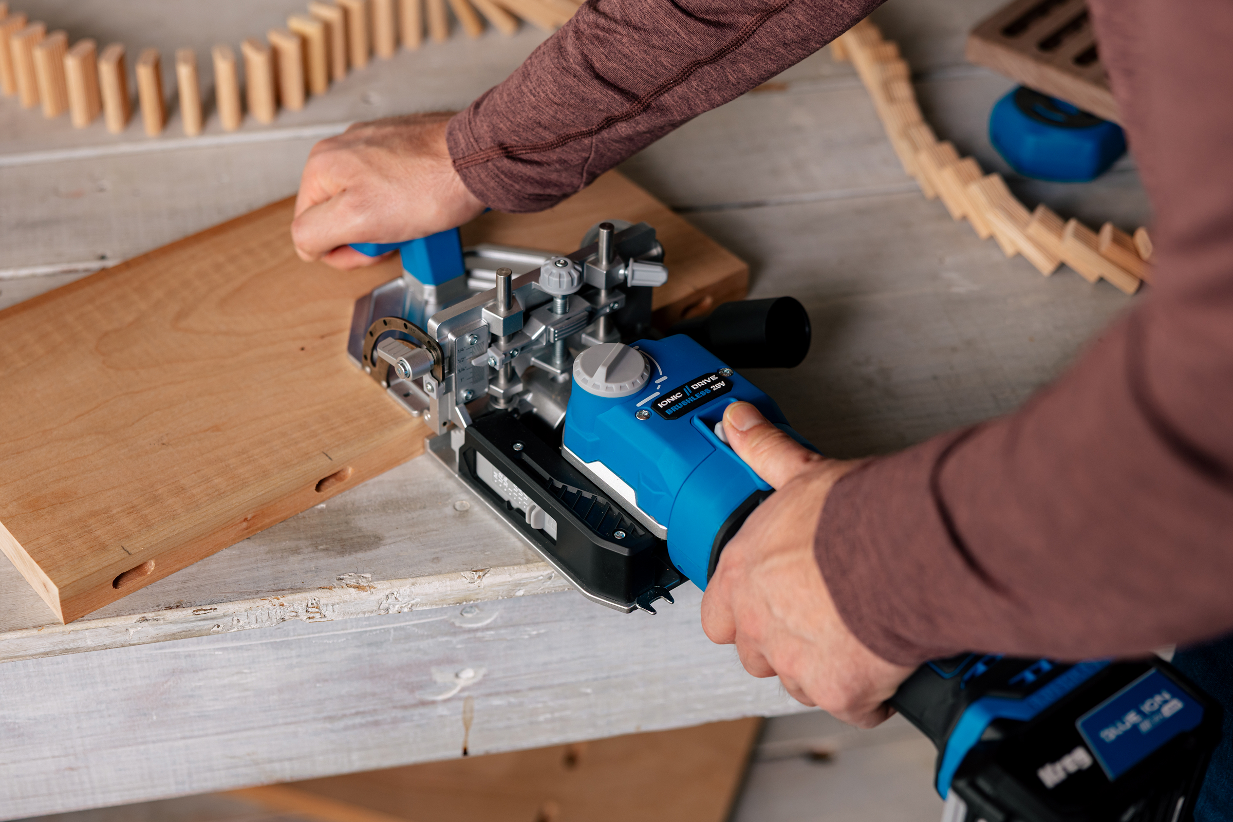 A man drilling a mortise into a hardwood board using the Kreg Edge Loose Tenon Joiner