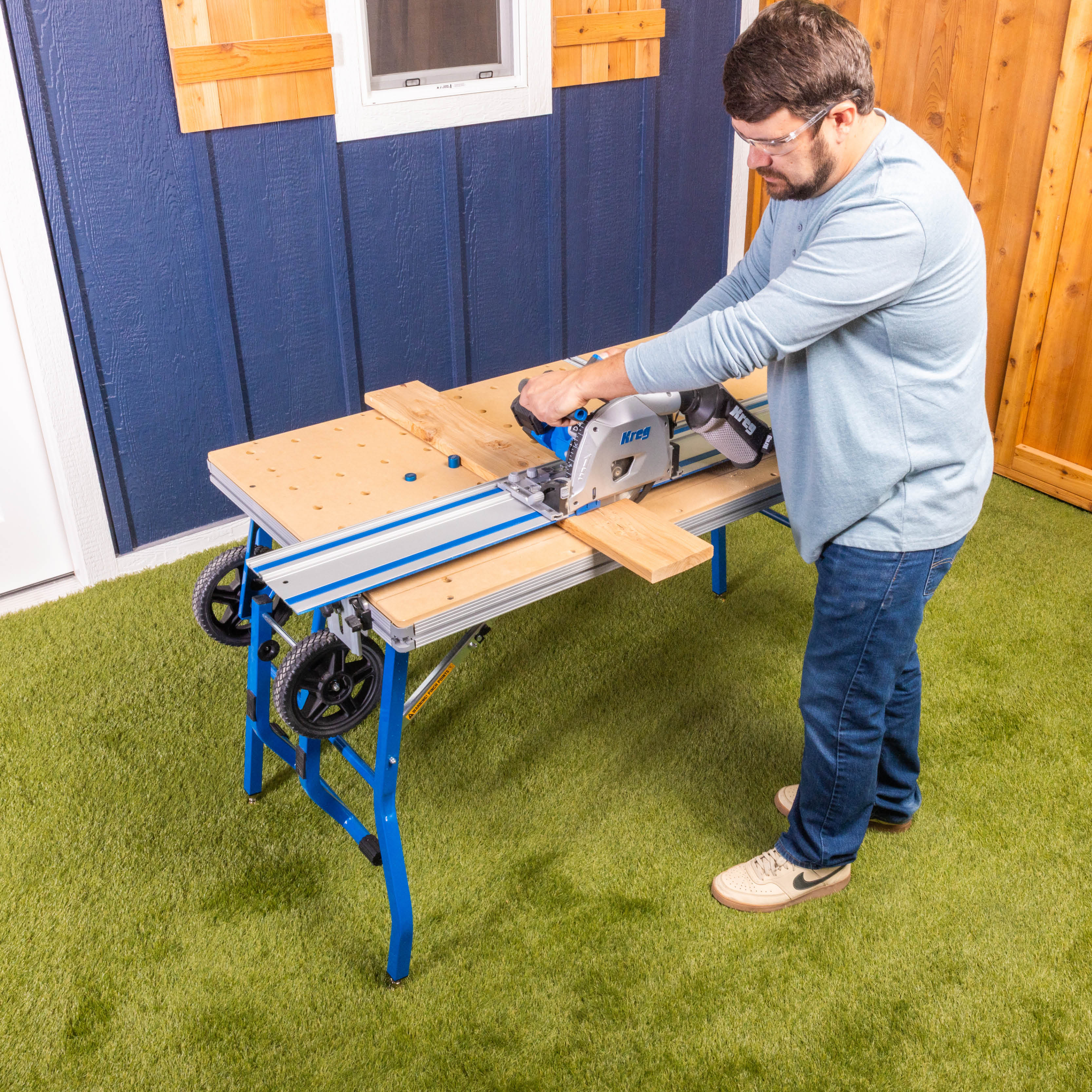 A man cuts a board on his Adaptive Cutting System table. 