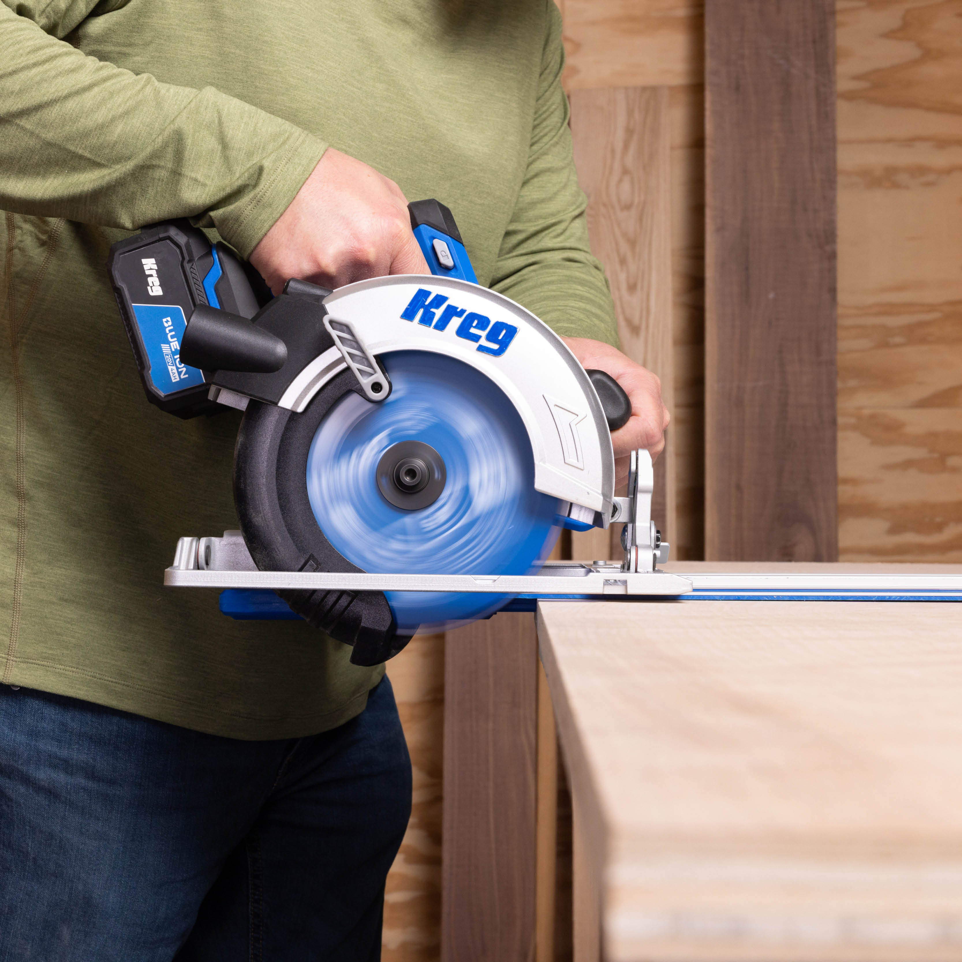 A man pushes the Kreg Circular saw along the Kreg universal track. 